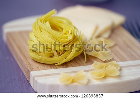 Raw macaroni and cheese on the board