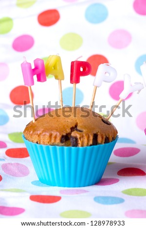 Festive  Cupcake Topped with Colorful Sprinkles and Happy Birthday Sign on White Background