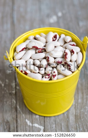 White beans in a yellow bucket