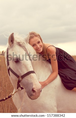 beautiful young woman with a  horse in the forest