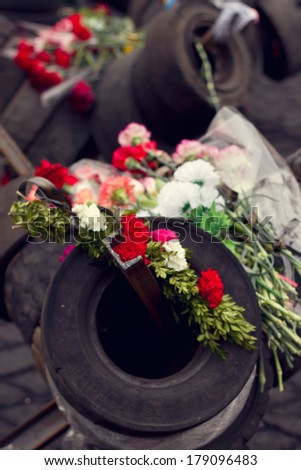 KIEV, UKRAINE, FEBRUARY 27, 2014:  flowers on the tires in the memory of those killed on evromaydane