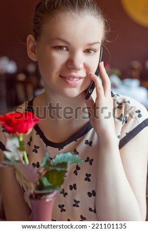 woman talking on cell phone in outdoor cafe
