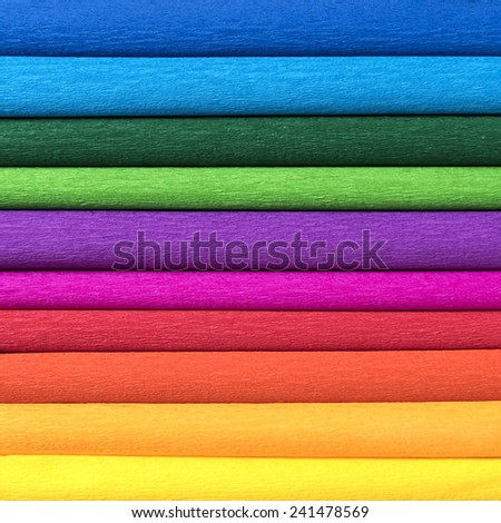 rolls of colored corrugated paper closeup on background