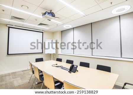 Small empty meeting room with TV projector and flipchart