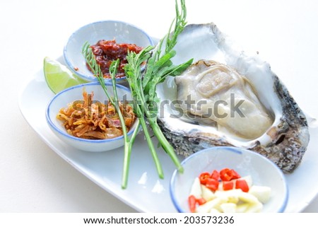 Uncooked oyster on restaurant eat with side dish
