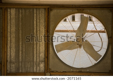 Rustic window fan in an old garage