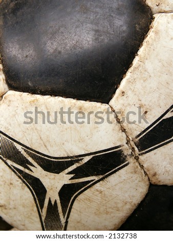 Old dirty soccer ball detail close-up. Macro