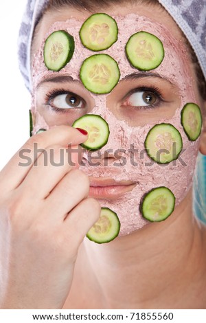 Portrait of young sexy woman making skincare mask