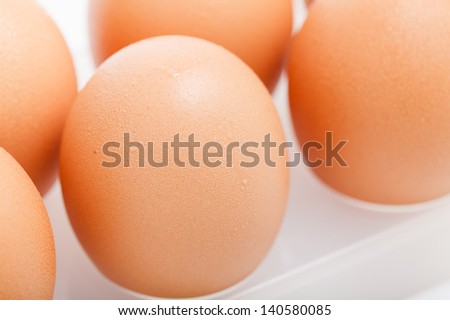 Closeup of fresh eggs in plastic tray