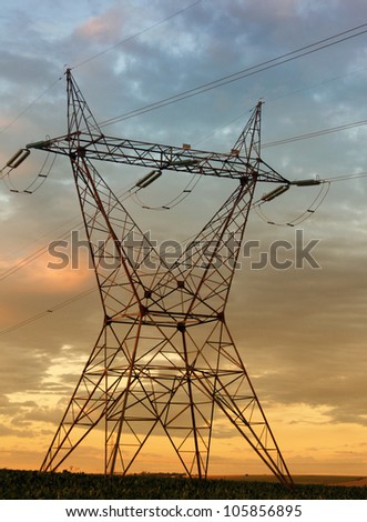 Eletricity tower providing energy distribution over sunset