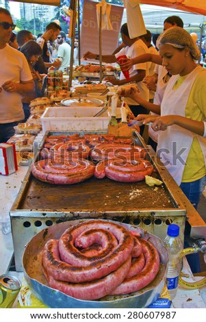 SAO PAULO, BRAZIL - MAY 17, 2015: An unidentified group of people in the hand made sausage sandwich stand in street fair market in Sao Paulo.