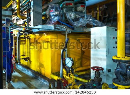 Closeup of manometer, pipes and faucet valves of heating system in a boiler room
