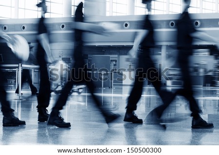 A Group Of Airport Security Crew Walking In The Airport