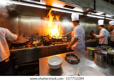 Crowded kitchen a narrow aisle working chef Crowded kitchen a narrow aisle working chef