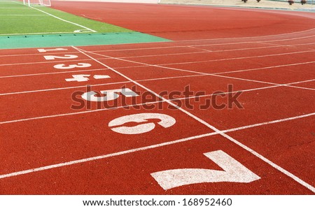 red plastic runway and numbers in a sports ground