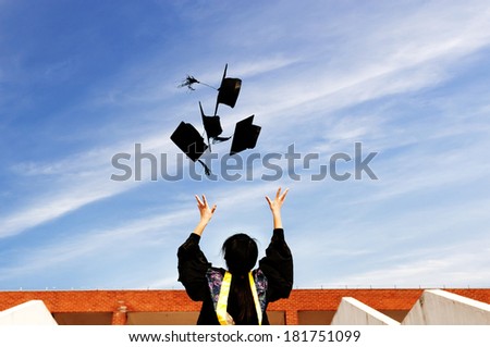 pretty graduate throwing graduation hats in the air.