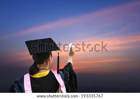 Beautiful female graduate wearing a graduation gown, throwing airplane