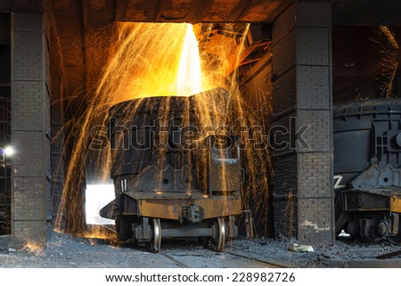 Smelting metal in a metallurgical plant. Liquid iron from the ladle