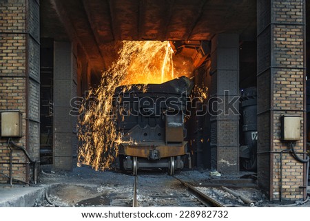 Smelting metal in a metallurgical plant. Liquid iron from the ladle