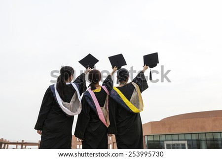 Beautiful female graduates wearing a graduation gown