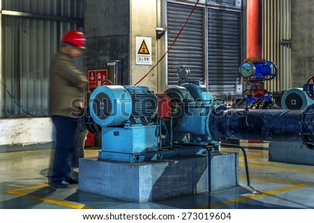 maintenance engineer checking technical data of heating system equipment in a boiler room