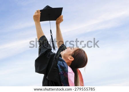 Beautiful female graduate wearing graduation gown
