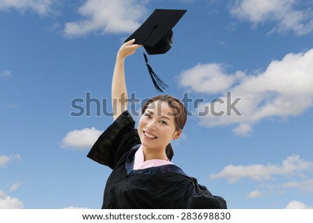 Beautiful female graduate wearing graduation gown