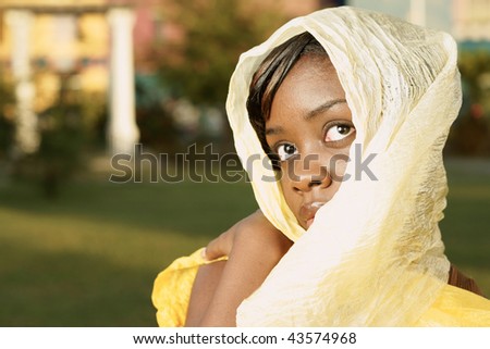 beautiful woman with golden head scarf with strong look