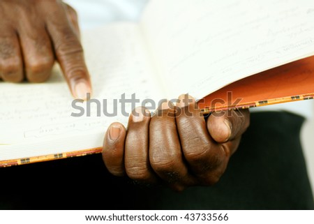 afro man reading his journal