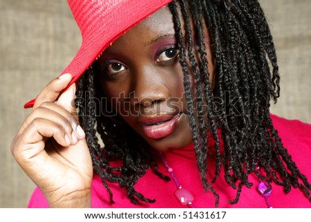 woman with red floppy hat looking at you intensely