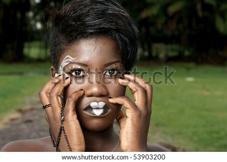 african woman wearing elegant face painting and gothic makeup