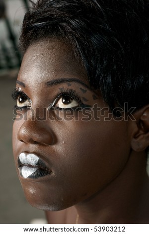 african woman wearing elegant face painting and gothic makeup