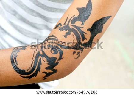 stock photo dragon tattoo on female arm