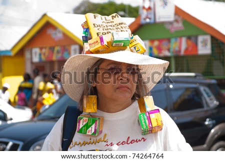 PORT OF SPAIN - FEBRUARY 26: A woman wears retro film packages to salute the photographic film era as she enjoys the Red Cross Kiddies Carnival February 26, 2011 in Port Of Spain, Trinidad & Tobago.