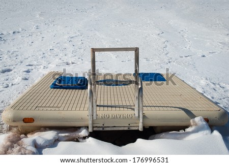 NO DIVING - Swimming platform trapped in ice on lake.