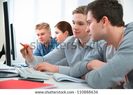 Group of students attending training course in a computer classroom