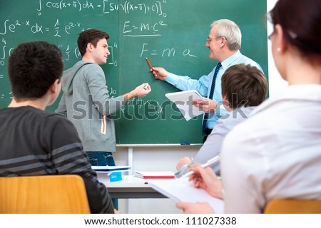 Teacher with a group of high school students in classroom