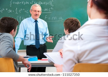Teacher with a group of high school students in classroom