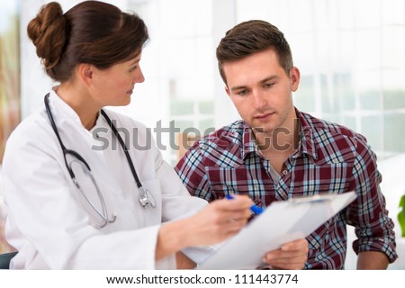 Doctor Talking To Her Male Patient At Office