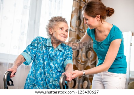 Senior woman with her caregiver at home
