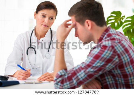 doctor talking to her male patient at office