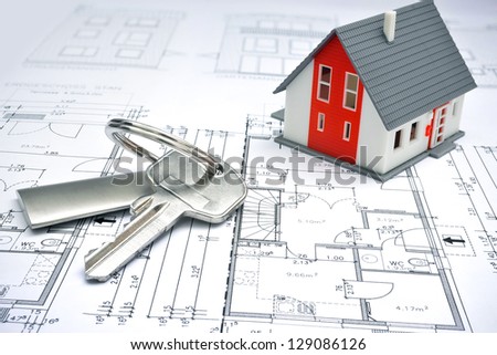 model of a house and key ring on a blueprint