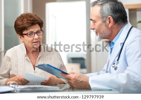 doctor talking to his female patient at office