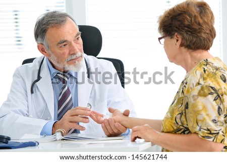 Physician examines the injured hand of the patient