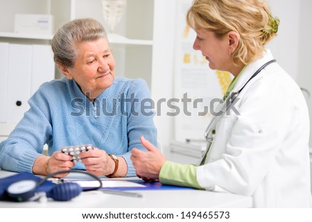 doctor prescribes medication to the senior patient