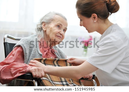 Female Nurse Is Taking Care Of The Senior Woman