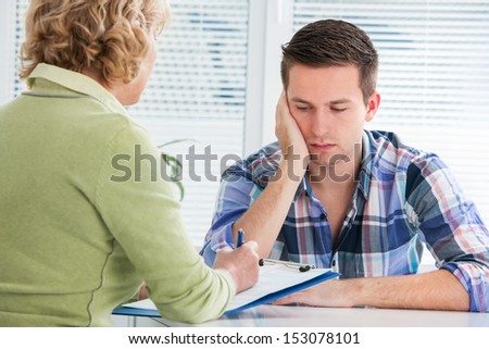 Young man visits doctors office suffering with depression
