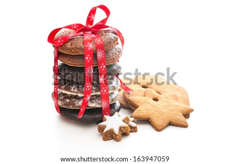 home baked christmas cookies on white with red ribbon