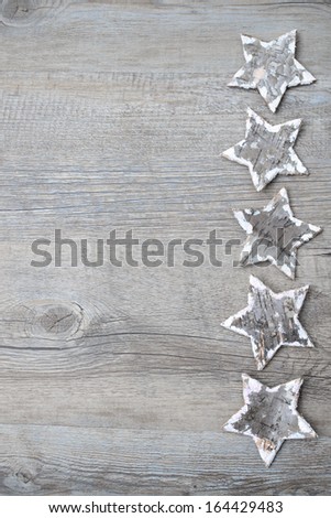 Christmas decoration from birch bark stars over the wooden background
