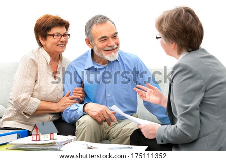 Senior couple meeting with real estate agent